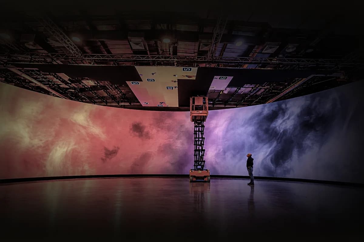 Crew member dwarfed by the curved LED wall and ceiling